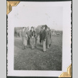 Woman in fur coast with group of men (ddr-densho-434-83)