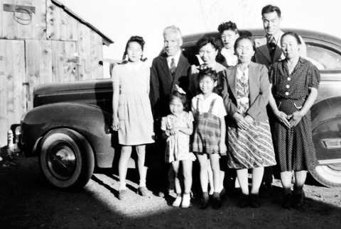 Family standing in front of car (ddr-densho-5-19)