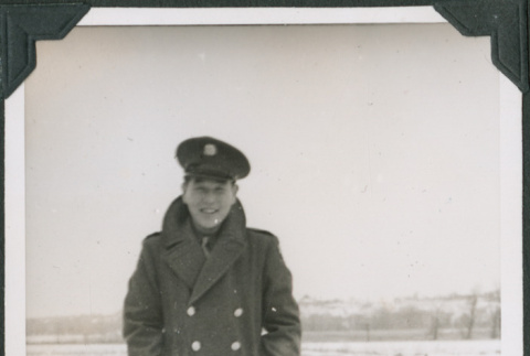 Man in overcoat in uniform standing in snow (ddr-ajah-2-440)