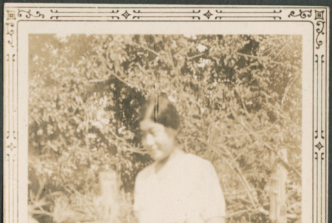 Woman standing in garden (ddr-densho-316-260)