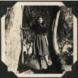 Tomoye (Nozawa) Takahashi standing in tree (ddr-densho-423-548)