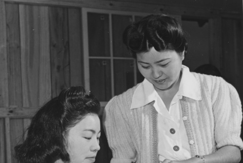 Misae Oku receiving instruction from instructor, Mrs. Sadako Yasue (ddr-csujad-14-22)