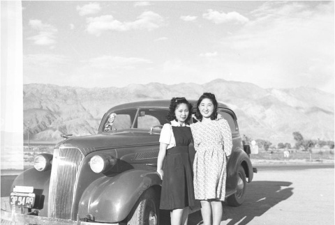 Two Nisei women in front of a car (ddr-densho-153-311)