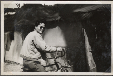 Man riding bicycle (ddr-densho-466-131)