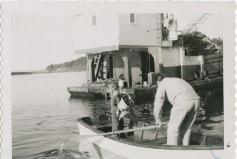 A girl being rowed away from an oyster barge (ddr-densho-296-86)