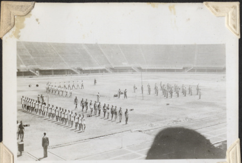 Men standing in rows in stadium (ddr-densho-466-729)