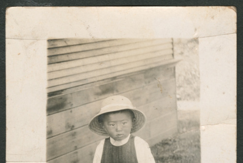 Child pushing a wheelbarrow (ddr-densho-433-789)