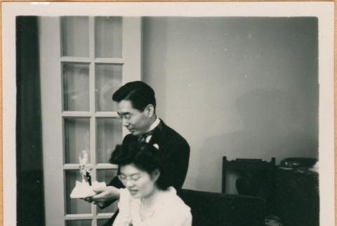 Henri Takahashi holding cake topper, Tomoye (Nozawa) Takahashi holding flowers (ddr-densho-410-513)