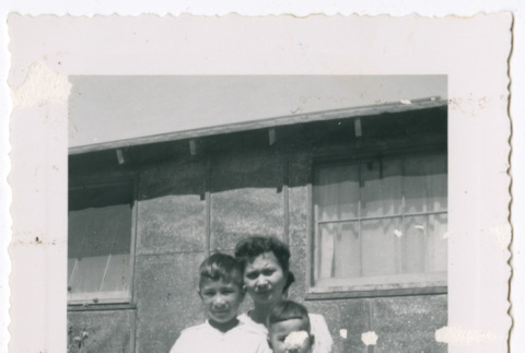 Photo of a woman with two children outside a barrack (ddr-densho-483-42)