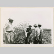 Man holds a daikon radish (ddr-densho-37-1392)