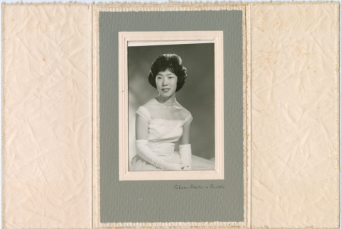 Studio portrait of woman in gown, photo folder (ddr-densho-430-247)
