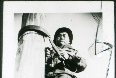 Man climbing pole (ddr-densho-1007-794)