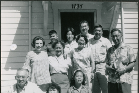 Group of 11 by door to house (ddr-densho-523-391)
