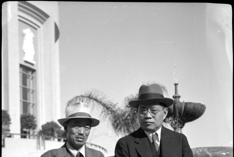 Tomoyuki Nozawa and unknown man standing by fountain (ddr-densho-426-1727)