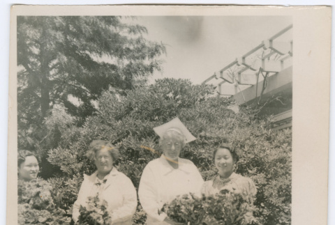 Four women with bouquets (ddr-densho-329-834)