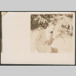 Woman sitting by greenery (ddr-densho-433-794)