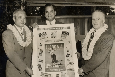 Three men holding a Pan American publicity poster (ddr-njpa-2-598)
