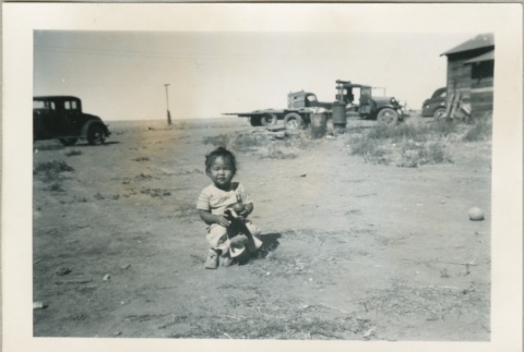 A toddler playing outside (ddr-densho-300-65)