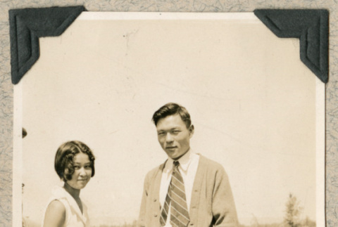 Man and woman standing next to car (ddr-densho-383-265)