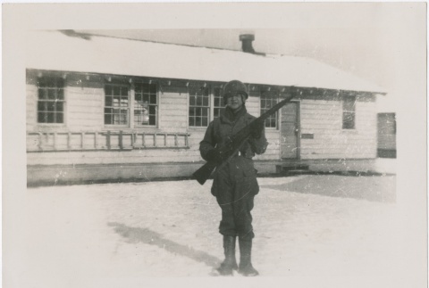 A soldier posing with a rifle in the snow (ddr-densho-273-10)