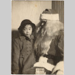 Photo of Diana Lynn Reiko Morita with Santa (ddr-densho-409-5)