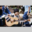 Naomi Takagi playing guitar (ddr-densho-336-995)