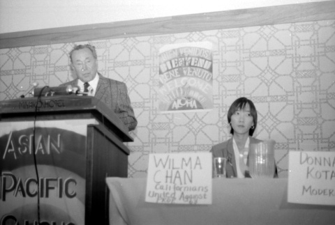 Stanley Diamond speaking, Wilma Chan at table (ddr-densho-1007-531)