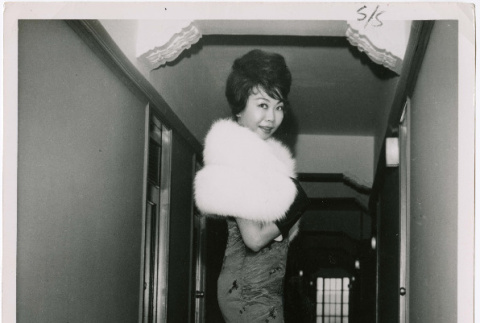 Mary Mon Toy in a fur shawl standing in hallway (ddr-densho-367-301)