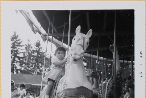 Leslie Shiomi on Merry-go-round (ddr-densho-522-446)