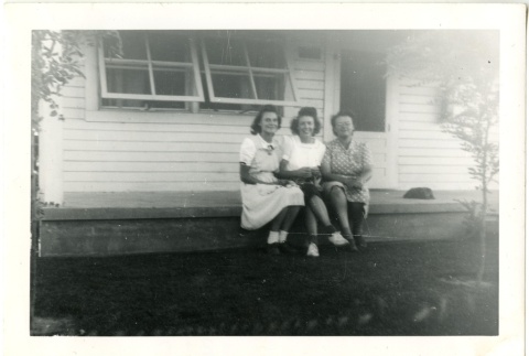 Three women sitting on a porch (ddr-manz-7-125)