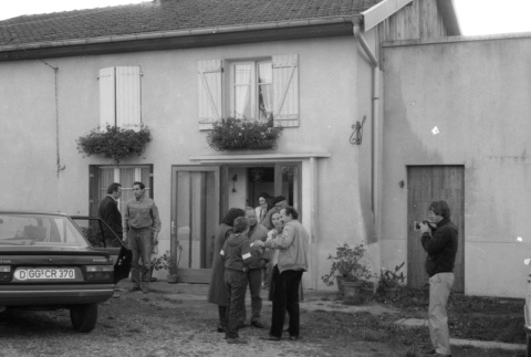 Loni Ding and group outside house (ddr-densho-1007-564)