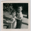 Masako Takahashi riding tricycle, with Norman (?) (ddr-densho-426-968)