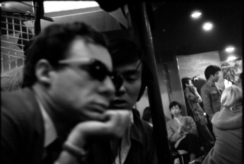Man in sunglasses talking with another man in bar or cafe (ddr-densho-426-2381)