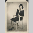 Signed photograph of a woman sitting in a chair (ddr-manz-10-5)