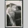 Man leaning on car with someone inside (ddr-densho-550-142)