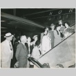 Group of people on aircraft ramp welcoming woman in kimono (ddr-densho-332-35)