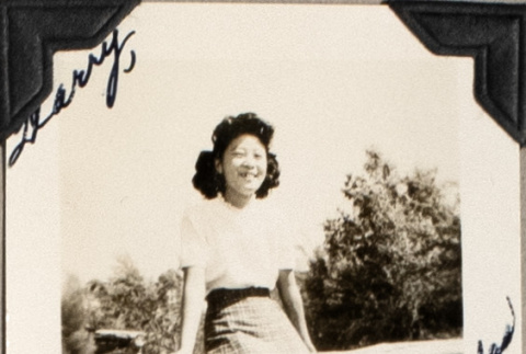 Woman sitting on railing (ddr-densho-587-54)