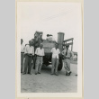 Men stand with a truck bound for Tule Lake (ddr-densho-37-876)