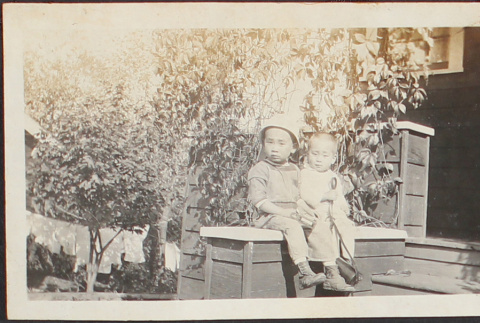 Two boys sitting on porch (ddr-densho-278-153)