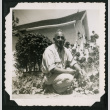 Harry Matsuoka kneels in a garden (ddr-densho-390-105)