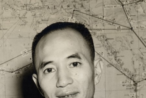 Man posing in front of a map (ddr-njpa-2-962)