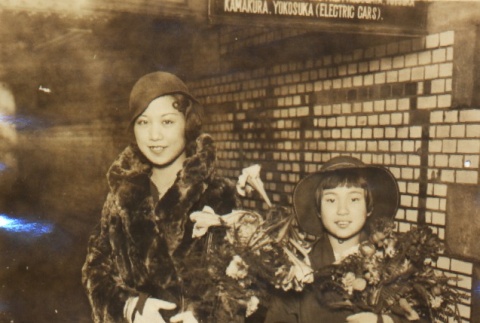Woman and a girl posing holding flowers (ddr-njpa-4-20)