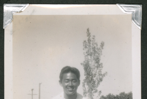Teenage boy sitting on bleachers (ddr-densho-550-138)