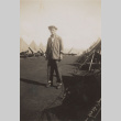 Man in middle of dirt road (ddr-janm-17-59)