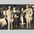 Two women holding bouquets, posing with husbands (ddr-njpa-4-137)