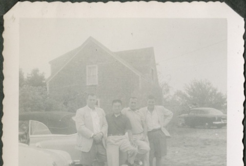 Four men leaning on a car (ddr-densho-321-326)
