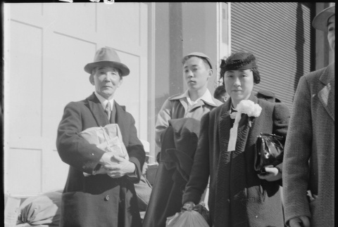 Japanese Americans waiting with baggage (ddr-densho-151-104)