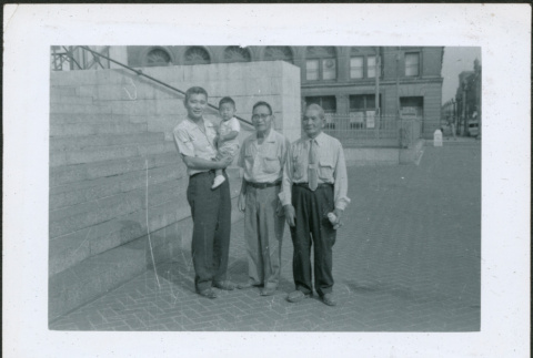 Three men and a baby near stairway (ddr-densho-293-184)