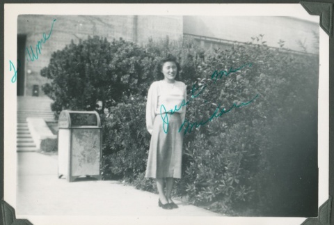 A woman standing in front of a building (ddr-densho-328-454)