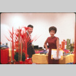 Man and woman standing by table display (ddr-densho-426-368)